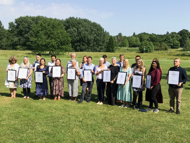 Picture of the Winners of each category gathered together holding certificates